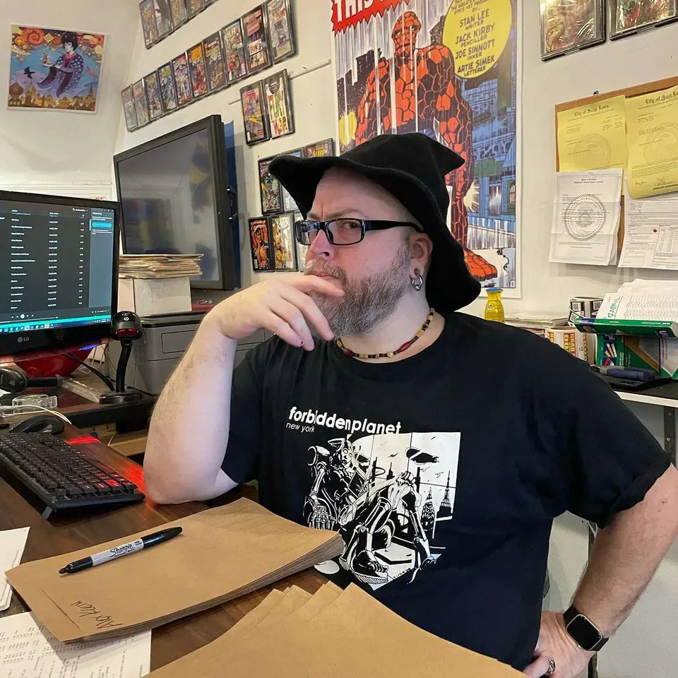 Ivan at a comics shop desk